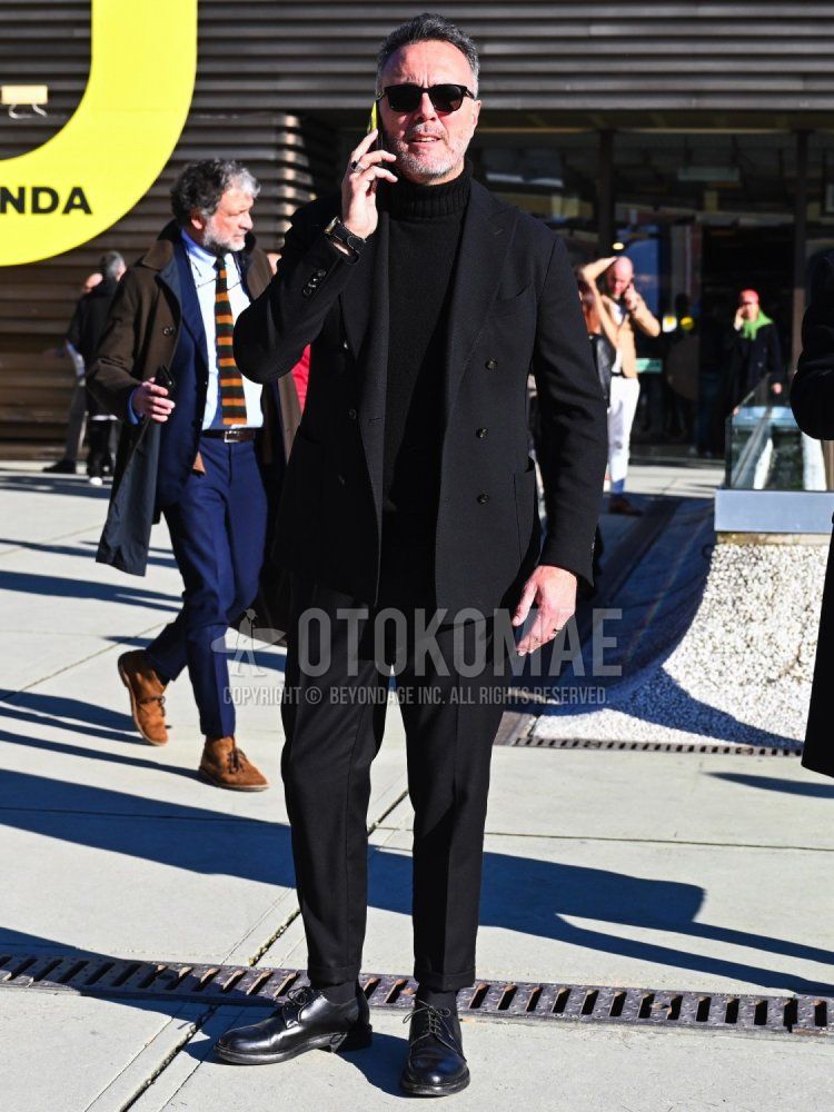Men's fall/winter/spring outfit with plain black sunglasses, plain black turtleneck knit, plain black socks, black plain toe leather shoes, and plain black suit.