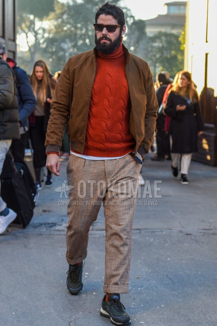 Brown tortoiseshell sunglasses, solid beige swing top, solid orange turtleneck knit, beige checked slacks, beige checked pleated pants, solid orange socks, Nike Air Max 97 gray low cut sneakers for fall/winter. Men's Codes and Outfits.
