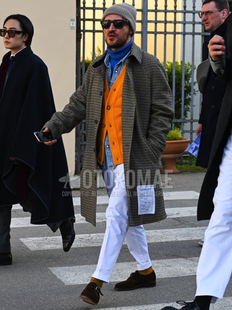 Solid gray knit cap, solid black sunglasses, gray zebra stainless steel coat, solid blue turtleneck knit, solid orange cardigan, solid blue denim/chambray shirt, solid white slacks, yellow striped socks, brown monk shoes. Men's fall/winter outfits with leather shoes.