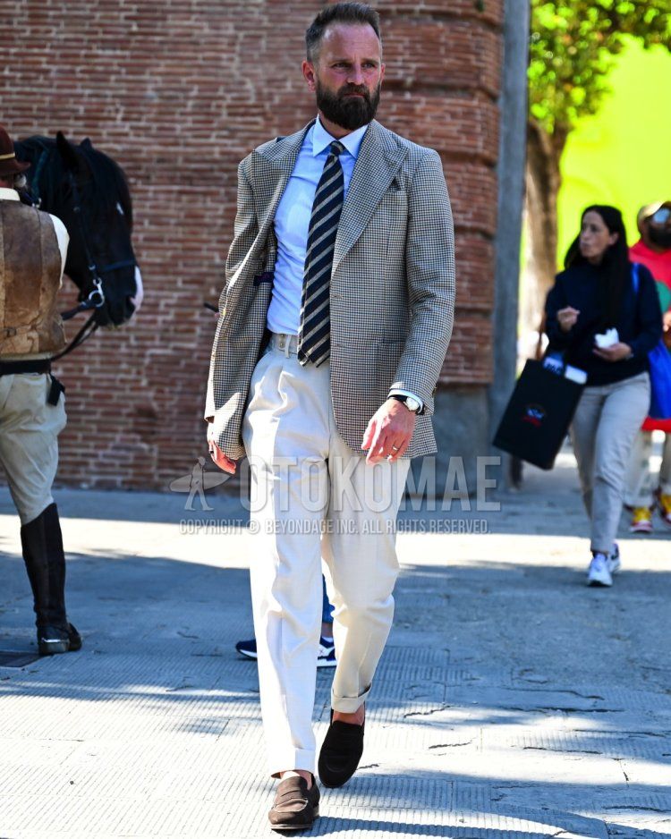 Men's fall/summer/spring outfit with gray checked tailored jacket, solid light blue shirt, solid white slacks, solid white pleated pants, brown coin loafers leather shoes, brown suede shoes leather shoes, navy regimental tie.