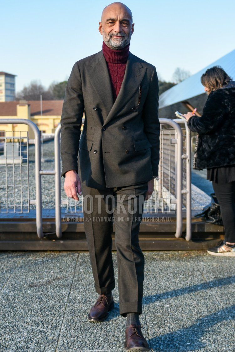 Men's spring and fall coordinate and outfit with red solid color turtleneck knit, gray solid color socks, brown wingtip leather shoes, and gray solid color suit.