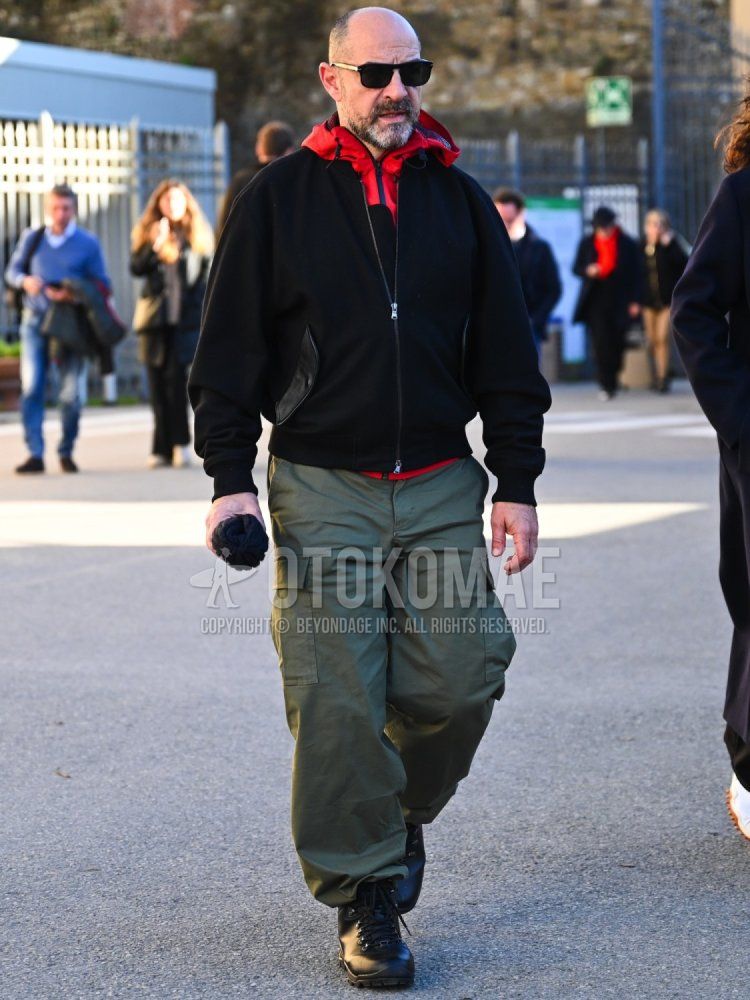 Men's fall/winter outfit/coordination with plain black sunglasses, plain red windbreaker, plain black MA-1, plain olive green cargo pants, plain olive green work pants, and black work boots.