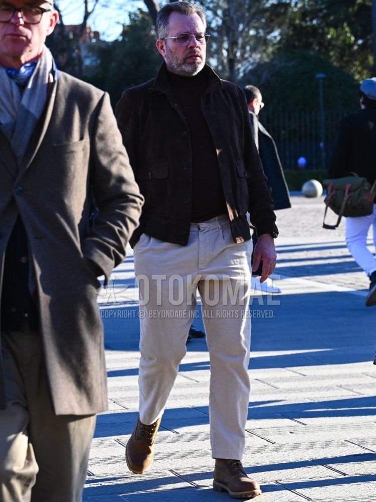 Men's winter/fall coordinate/outfit with clear solid sunglasses, brown solid leather jacket (not riders), brown solid turtleneck knit, beige solid winter pants (corduroy, velour), brown work boots.