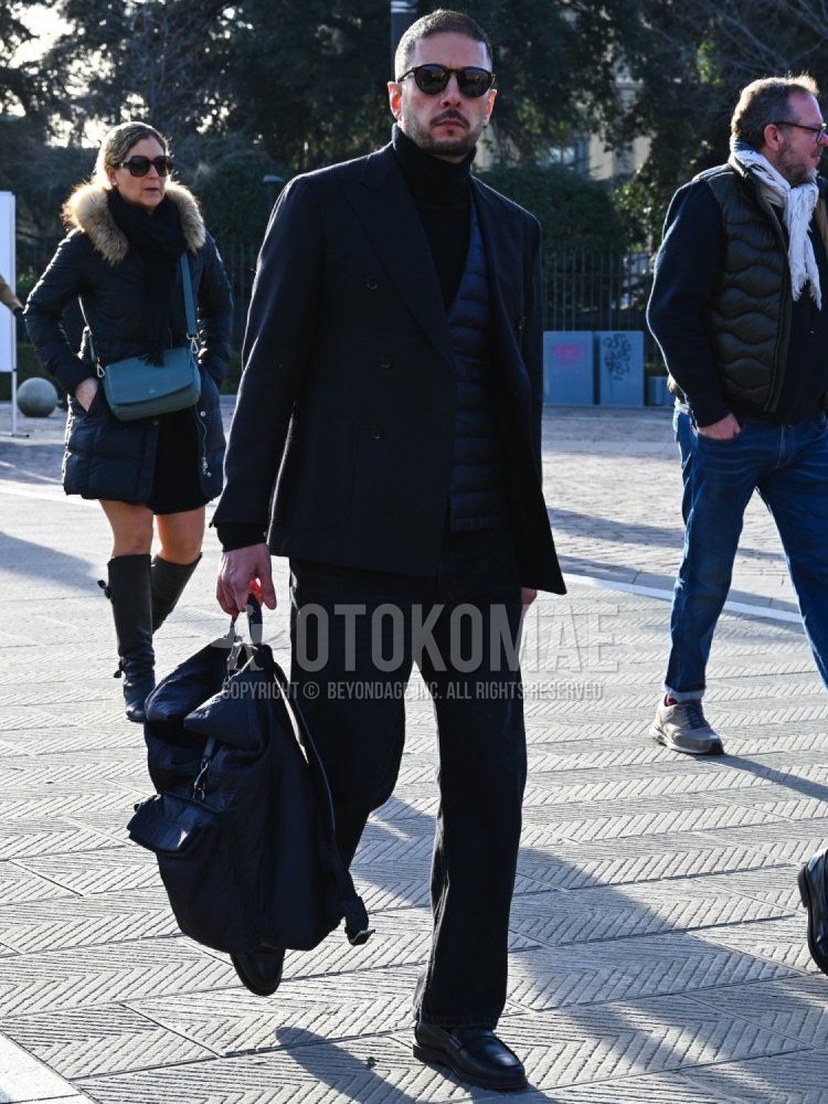 Men's fall/winter coordinate and outfit with solid black sunglasses, solid black turtleneck knit, solid black inner down, solid black backpack, and solid black suit.