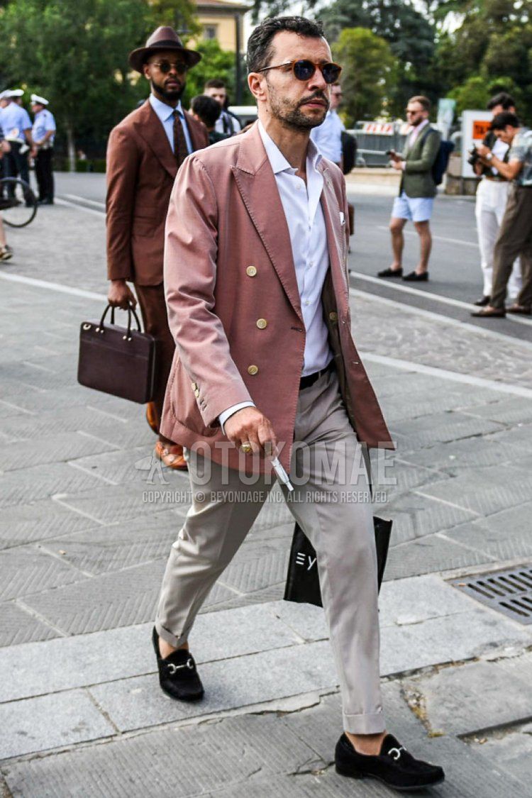 Men's spring and fall coordinate and outfit with brown tortoiseshell sunglasses, red plain tailored jacket, white plain shirt, beige plain slacks, and suede brown bit loafer leather shoes.