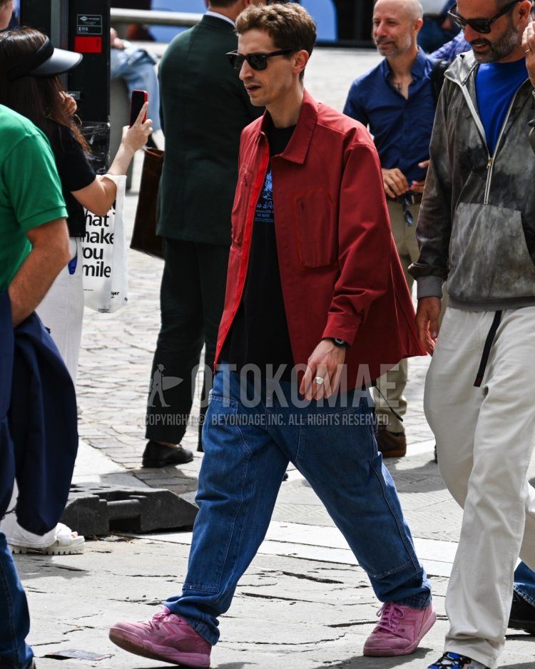 Men's spring/summer/autumn coordinate and outfit with solid black sunglasses, solid red coveralls, solid black t-shirt, solid blue wide pants, solid blue denim/jeans, and pink low-cut sneakers.