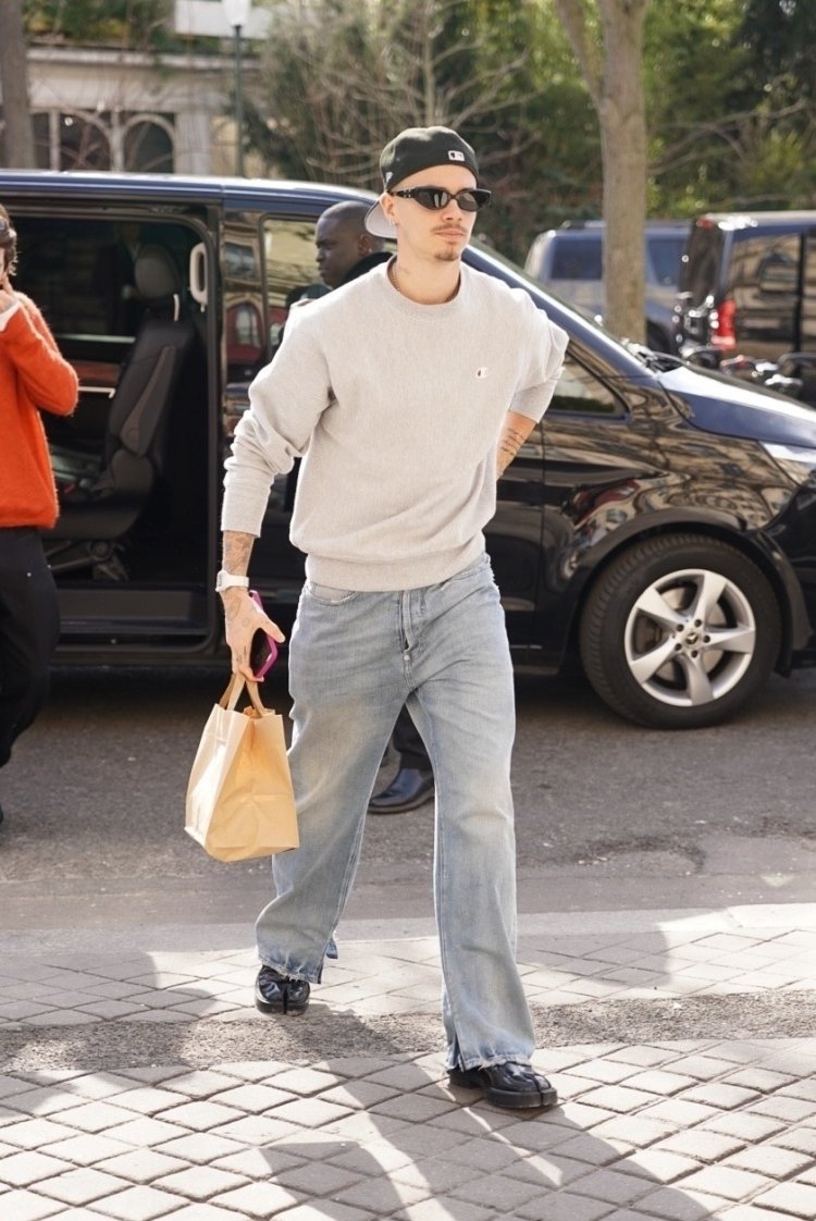 Cruz Beckham and girlfriend arrive at a Paris hotel with Romeo Beckham