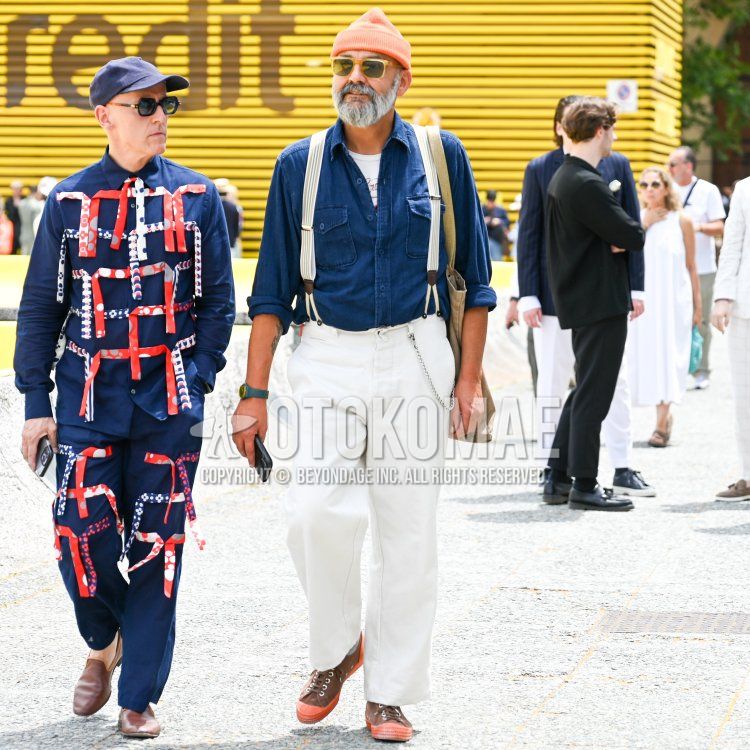 Men's spring/summer coordinate and outfit with plain orange knit cap, yellow tortoiseshell sunglasses, plain blue denim/chambray shirt, white one-pointed t-shirt, plain white suspenders, plain white denim/jeans, and orange-brown high-cut sneakers.