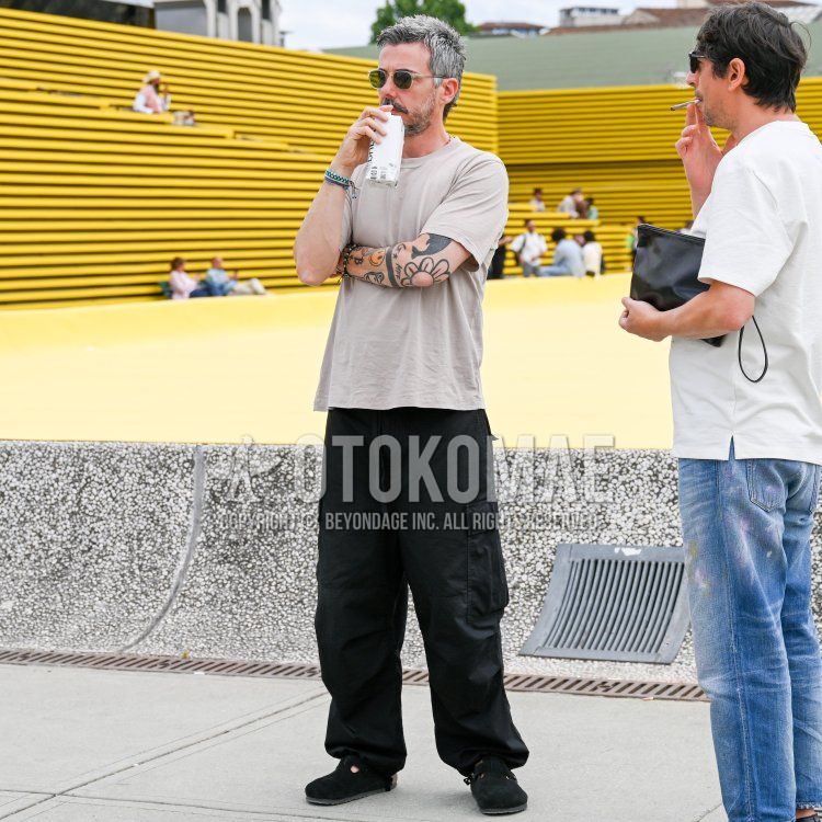 Men's summer coordinate and outfit with plain black/silver sunglasses, plain beige t-shirt, plain black cargo pants, and Birkenstock black leather sandals.