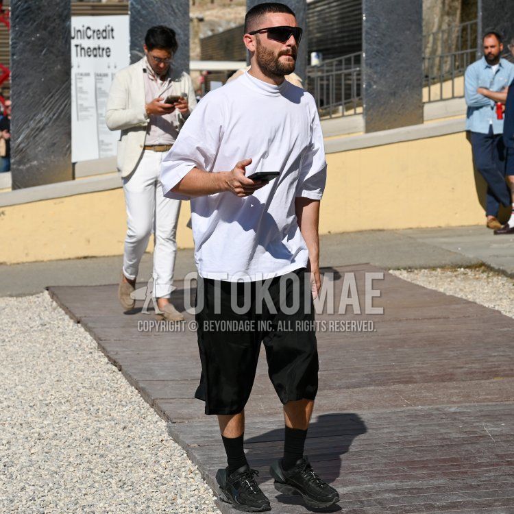 A summer men's coordinate and outfit with plain black sunglasses, plain white t-shirt, plain black shorts, plain black socks, and black low-cut sneakers.