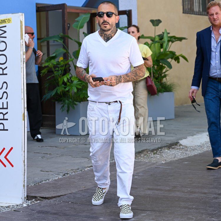 Summer/spring men's coordinate and outfit with plain black Wellington sunglasses, plain white t-shirt, plain white v-neck, plain brown mesh belt, plain brown leather belt, and Vans white and black slip-on sneakers.