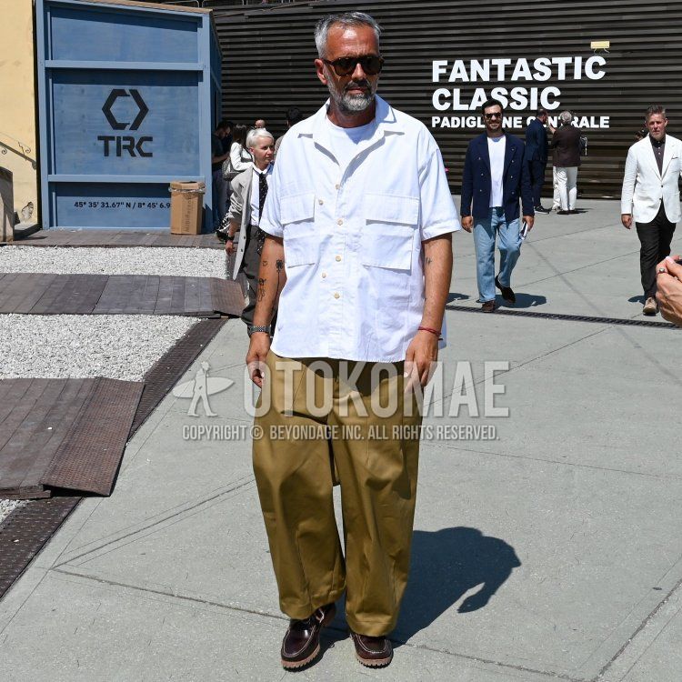 Summer/spring men's coordinate and outfit with black tortoiseshell sunglasses, plain white shirt, plain white t-shirt, plain beige chinos, plain beige pleated pants, brown moccasins/deck shoes leather shoes.