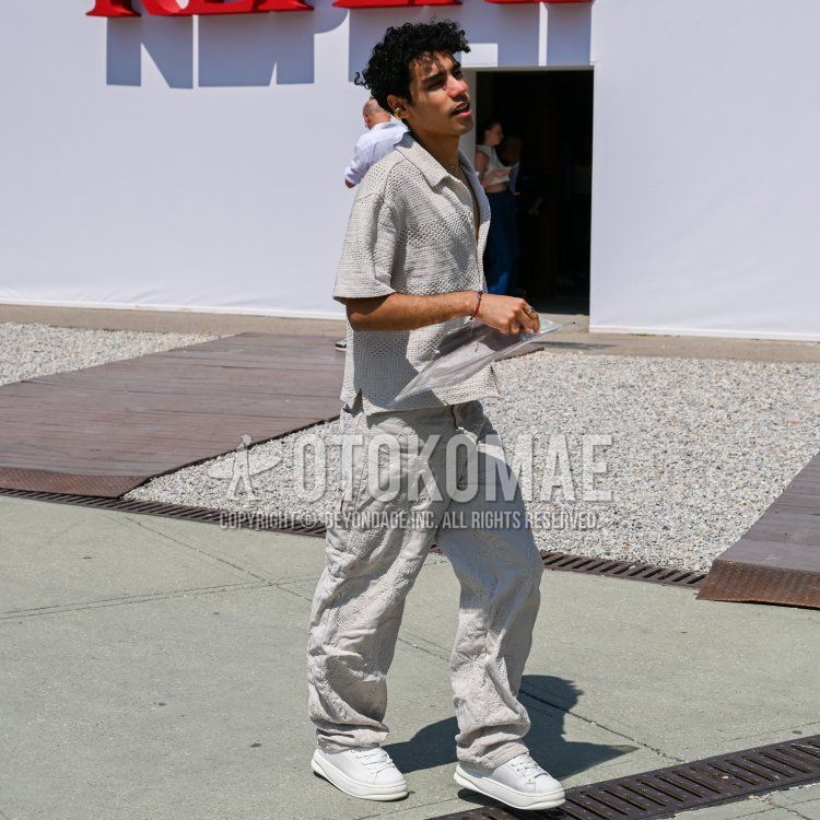 Summer/spring men's coordinate and outfit with knit plain gray shirt, gray bottom slacks, and white low-cut sneakers.