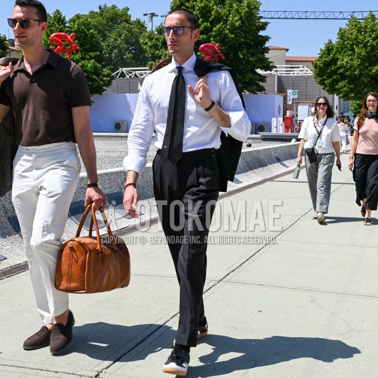 Men's spring/summer coordinate and outfit with plain black Tom Ford glasses, plain black tailored jacket, plain white shirt, plain black pleated pants, black low-cut sneakers, plain black suit, and plain black tie.