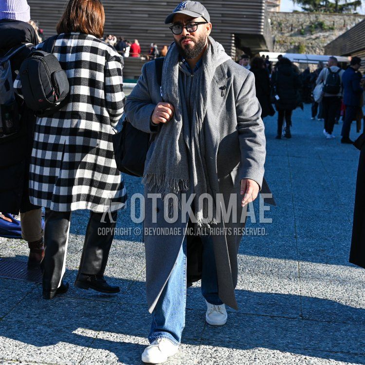 Gray one-pointed baseball cap, solid black glasses, solid gray scarf/stall, solid gray chester coat, solid light blue denim/chambray shirt, solid gray hoodie, solid light blue denim/jeans, solid white low cut sneakers, solid black backpack. Men's fall/winter outfits and outfits.