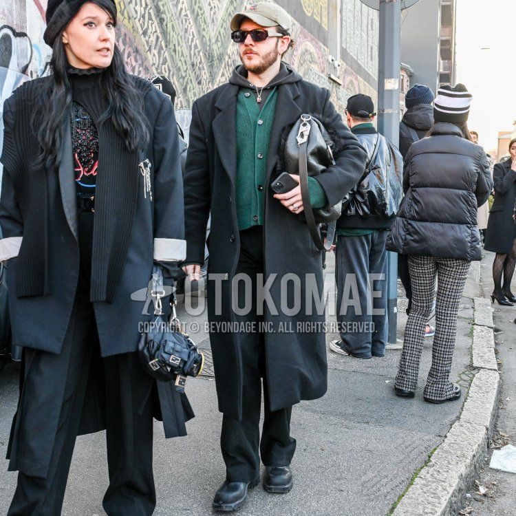 Winter men's coordinate and outfit with beige one-pointed baseball cap, solid brown sunglasses, solid dark gray chester coat, solid green cardigan, solid dark gray hoodie, solid black slacks, and black boots.