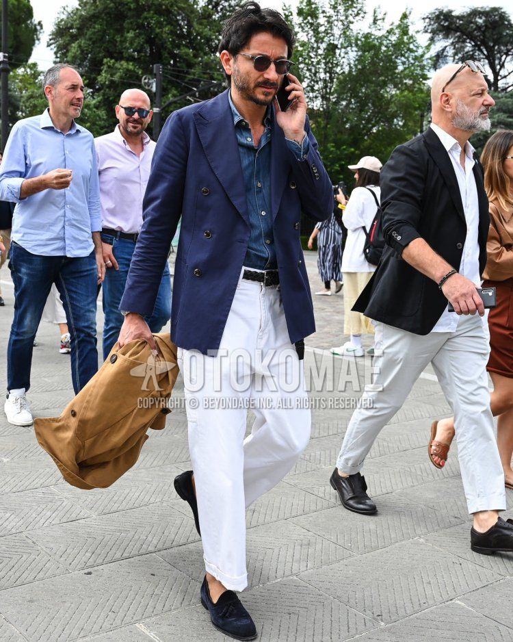 Men's fall/summer/spring outfit with solid black sunglasses, solid navy tailored jacket, solid blue denim/chambray shirt, solid black mesh belt, solid white slacks, and navy tassel loafer leather shoes.