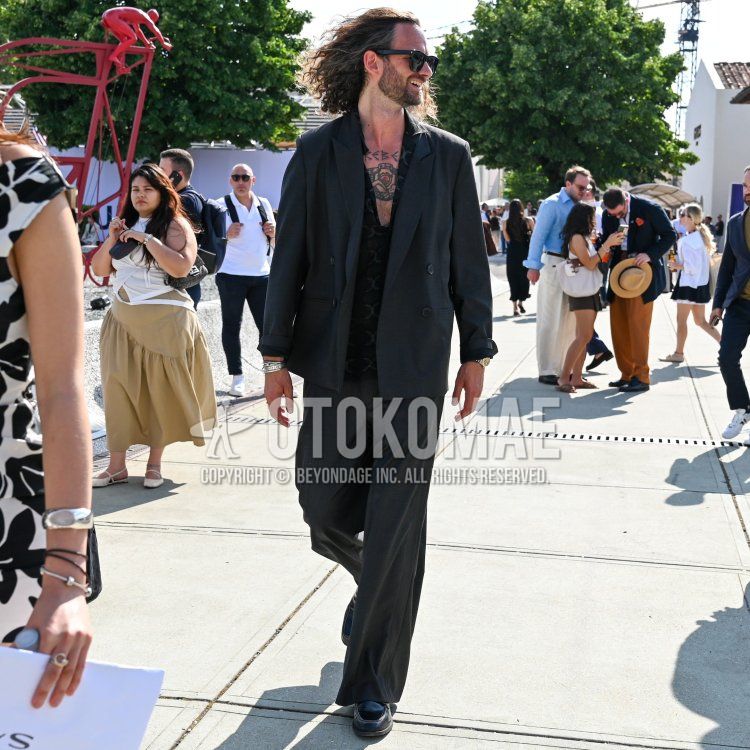 黒無地のサングラス、黒トップス/インナーのシャツ、黒コインローファーの革靴、黒無地のスーツを合わせた夏春のメンズコーデ・着こなし。