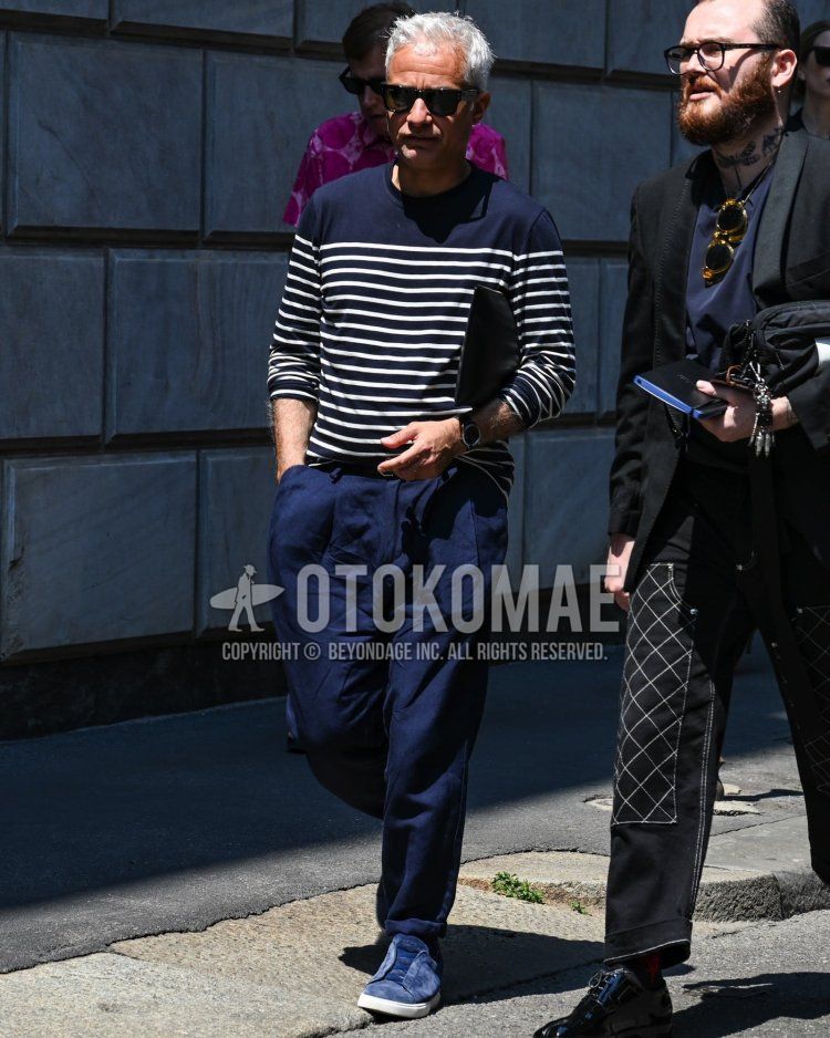 Men's spring, summer, and fall outfits with plain black sunglasses, plain navy/white long T, plain navy pleated pants, and Zegna blue slip-on sneakers.