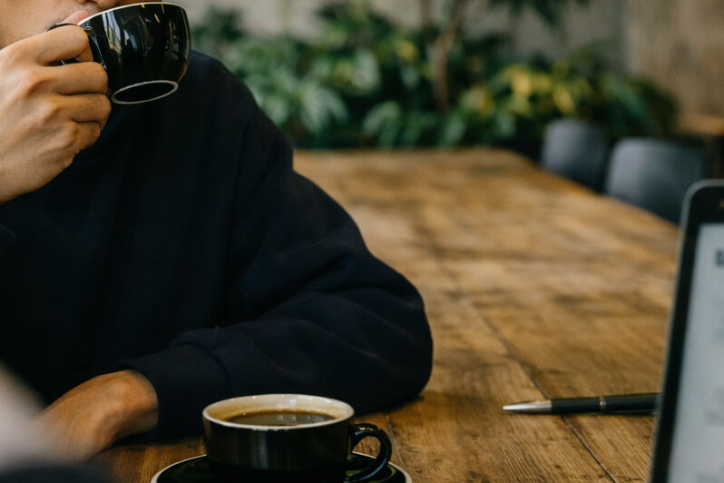 Mr. K taking a sip of coffee