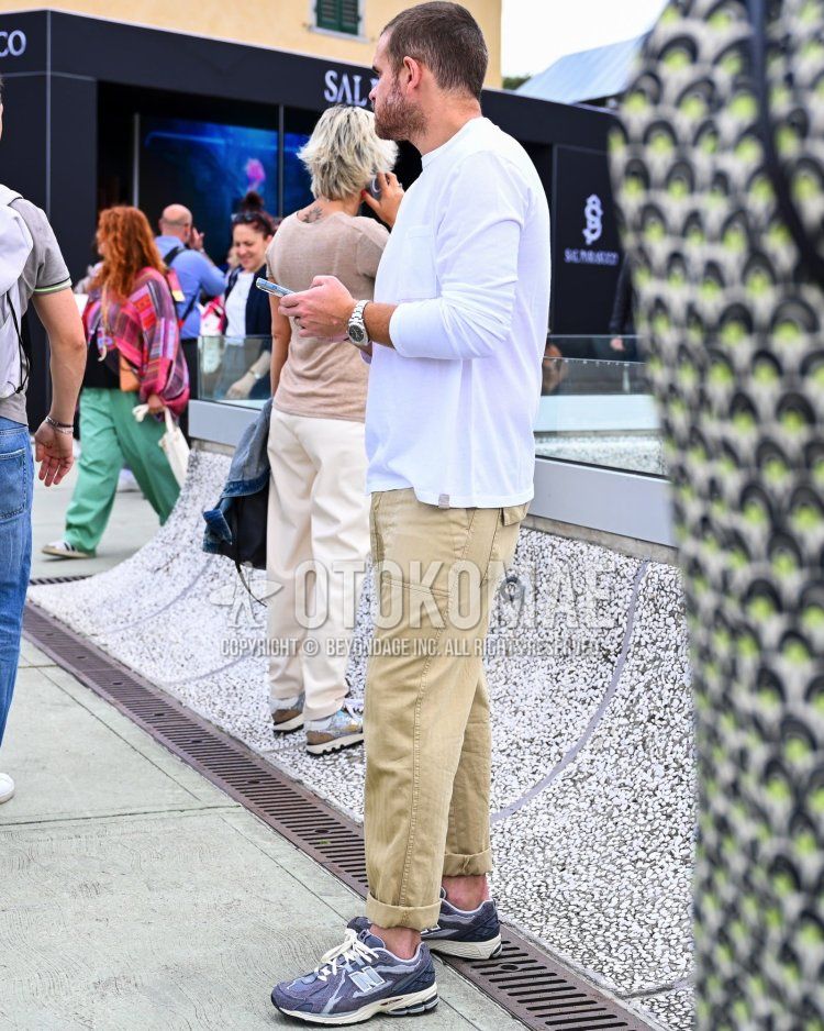 Men's fall/summer/spring coordinate and outfit with plain white long T, plain beige chinos, and New Balance purple low-cut sneakers.