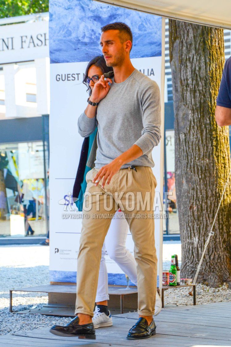 Men's spring, summer, and fall coordinate and outfit with plain gray long T, plain beige chinos, and black coin loafer leather shoes.