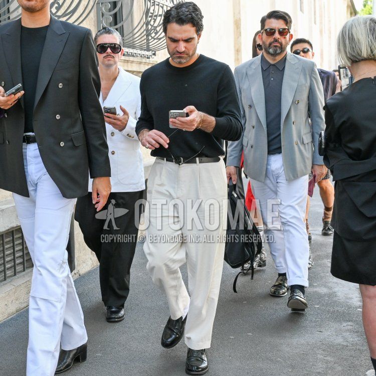 Spring men's coordinate and outfit with plain black long T, plain black leather belt, plain beige chinos, and black coin loafer leather shoes.