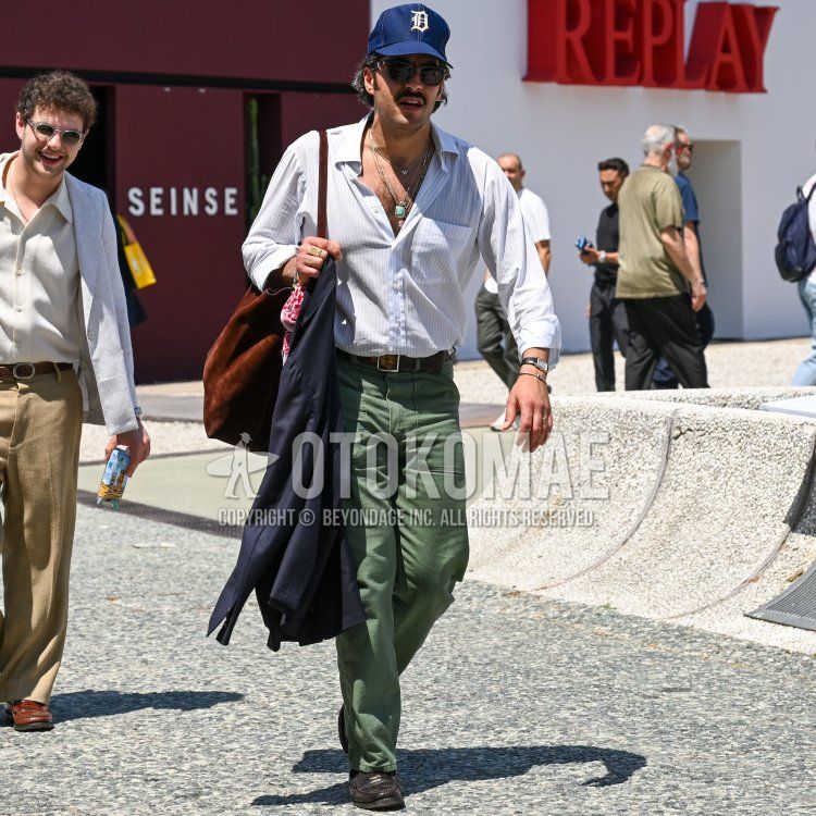 Navy lettered baseball cap, plain black Wellington sunglasses, red stole scarf, plain black outerwear, white striped shirt, plain brown leather belt, plain green baker pants, brown coin loafer leather shoes, plain brown tote bag. Men's spring and summer coordinates and outfits.