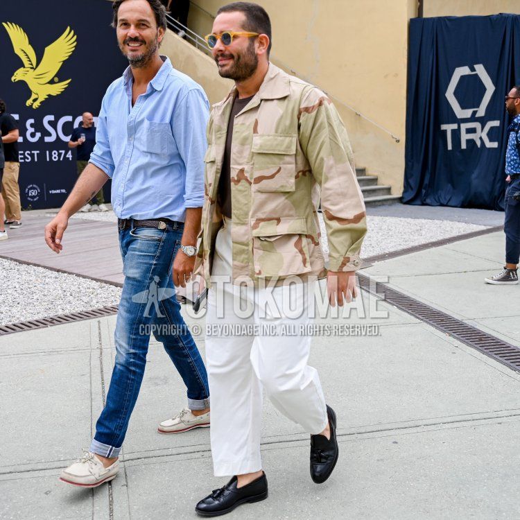 Men's spring and fall outfit with plain beige sunglasses, beige camouflage shirt jacket, plain brown t-shirt, plain white slacks, and black tassel loafer leather shoes.
