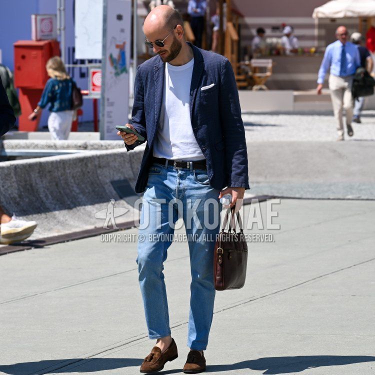 Solid silver sunglasses, navy check tailored jacket, solid white t-shirt, solid brown leather belt, solid blue denim/jeans, brown tassel loafers leather shoes, brown suede shoes leather shoes, leather brown solid briefcase/handbag. Summer/spring men's coordinate/outfit with.