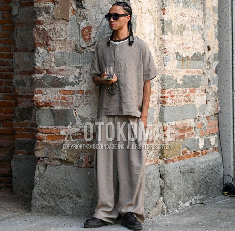 Summer/spring men's coordinate and outfit with plain black sunglasses, plain brown shirt with no collar, plain brown slacks, plain brown pleated pants, wide brown pants, and brown plain toe leather shoes.