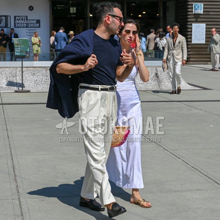 Ray-Ban brown tortoiseshell sunglasses, a solid navy outerwear piece, a solid navy T-shirt, a solid black mesh belt,a plain black leather belt, plain white slacks, plain white pleated pants, plain white ankle-length pants, and black leather loafers—a men’s spring/summer outfit and styling guide.