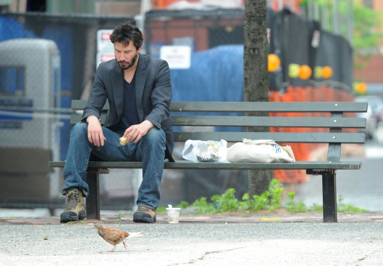 Keanu Reeves has lunch on a park bench in Soho NYC